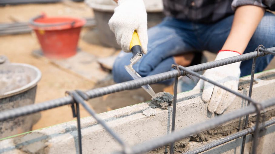bricklayer-worker-installing-brick-masonry-exterior-wall-with-trowel-putty-knife (1)